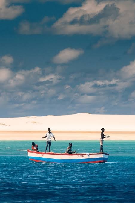 Local fishermen on a traditional wooden boat crossing the lagoon off Benguerra Island, Mozambique