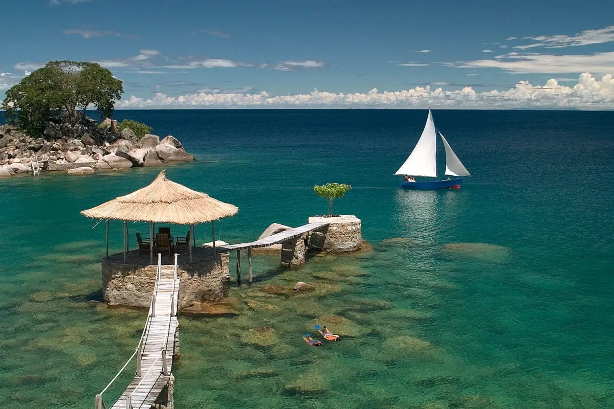 A private thatched-roof deck with lounge seating overlooking Lake Malawi