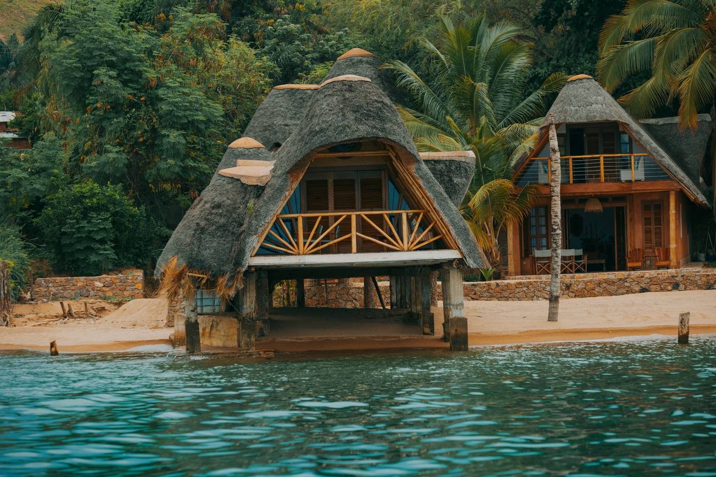 A thatched, stilted lake lodge on the shore of Lake Malawi, the final stop of a private safari circuit